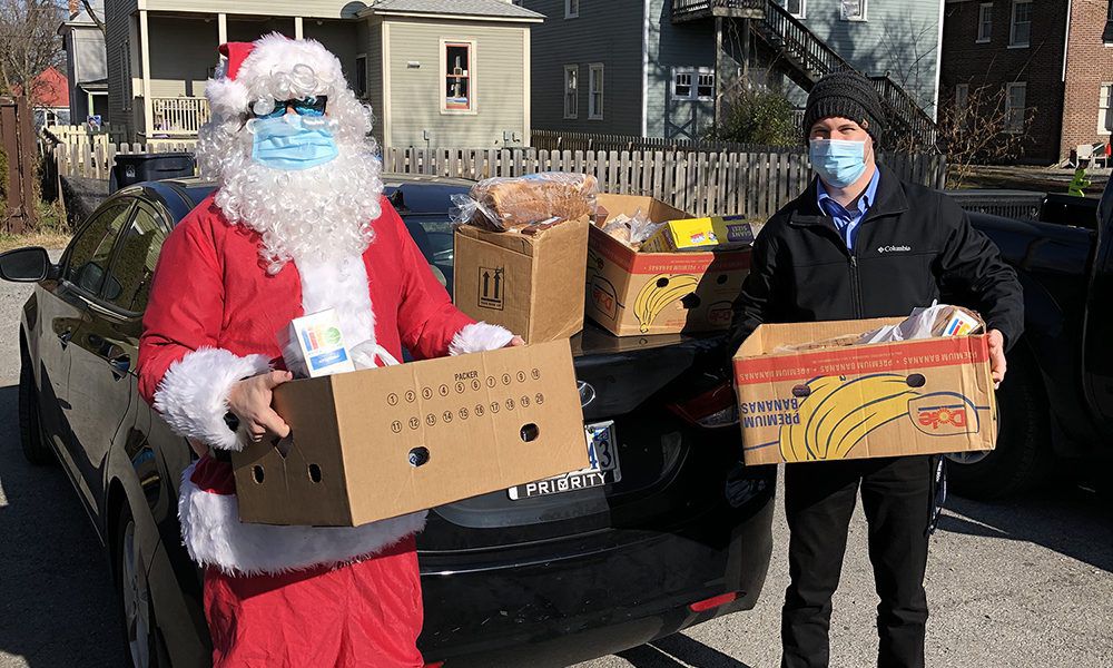 Santa Delivers to Food Bank with Hughes Employee